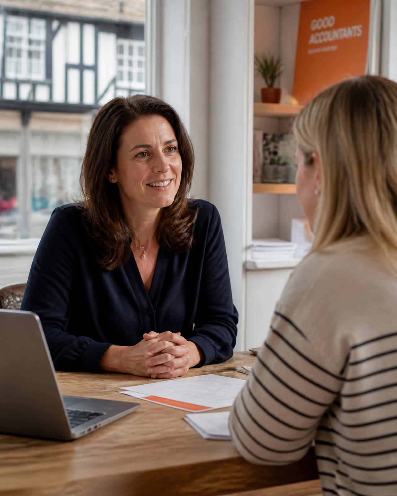 An accountant talking through figures with a business owner in a bright office